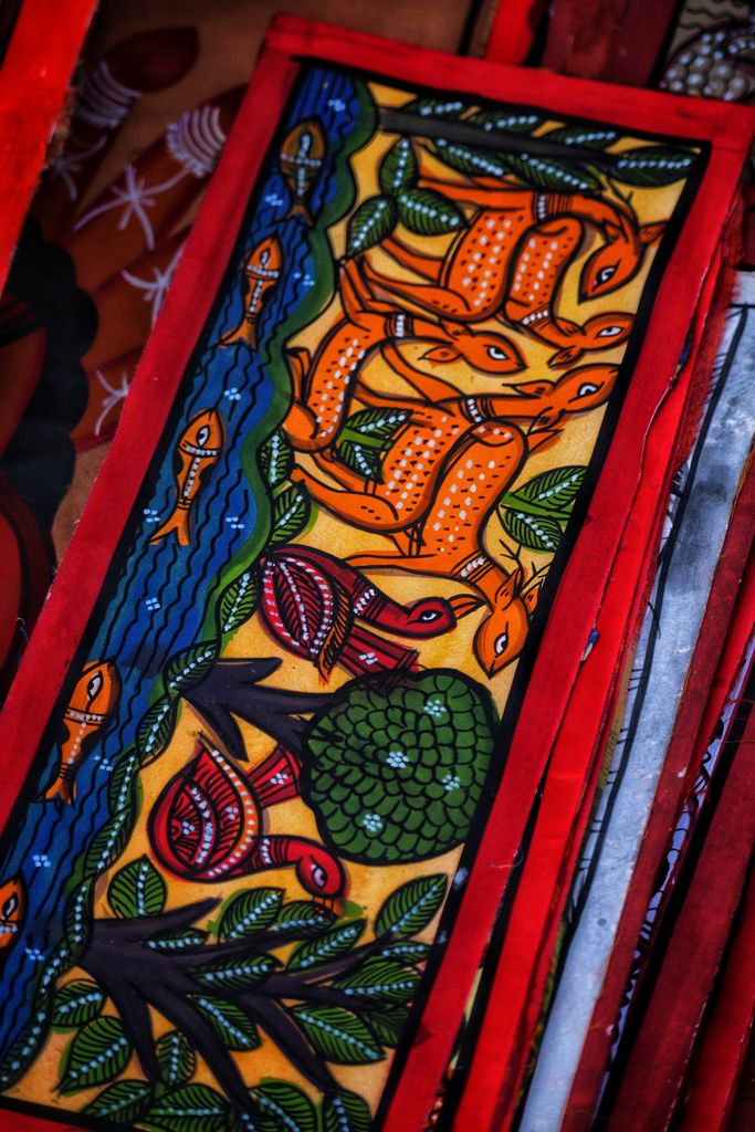 Colorful folk art painting featuring animals and nature elements with vibrant details.